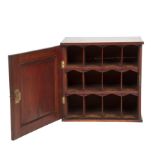 A 19th century mahogany cabinet with a single panel door opening to reveal pigeon holes 44cm wide