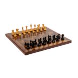 An Edwardian marquetry chess board 43cm x 43cm together with a part chess set. Board lays flat,