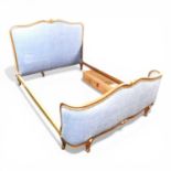 A modern French style double bedstead, upholstered in blue, with a slatted wooden base 218w x 153d x