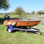A hand built vintage style wooden river boat, Riva Diva, with Suzuki 15hp outboard engine. Built