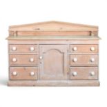 A 19th century stripped pine chiffonier, with a gallery back, on a plinth base 150w x 50d x 103h