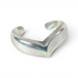 A sterling silver Tiffany bangle, by Elsa Peretti of wave cuff design, stamped marks, 28g, 65mm