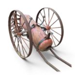 An early 20th century chemical fire cart, with a red painted cannon, on iron spoked wheels, 182cm