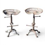 A pair of old cast iron tractor seat bar stools, with revolving seats (2)