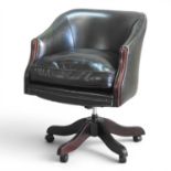 A green leather upholstered swivel desk chair, on a splayed base