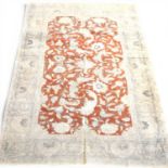 An Afghan part silk rug, with scrolling foliate designs on a red ground, 178 x 124cm