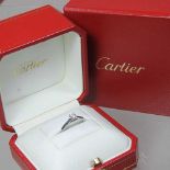 A Cartier platinum solitaire diamond ring, stamped 0.19, SX9924, 3.1g, size H, in a Cartier box