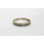 An 18ct diamond set half eternity ring, with alternating round and baguette cut diamonds, ring