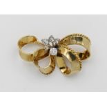 A yellow and white gold and diamond brooch in the form of a bow, set with five diamonds, 4.2 x 2.