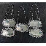 Nine wine / decanter labels - to include a set of five Elizabeth II cast silver decanter labels, J B