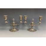 A pair of silver twin branch candelabra, EAW, Birmingham, 1984, having ribbed scrolling arms, to urn
