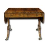 A very fine late Georgian rosewood sofa table, with satinwood inlay, the top flanked by two hinged