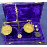 Small set of brass balance scales with weights in velvet case