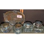 A late 19th/early 20th century Japanese bronze dish and four desk ink wells.