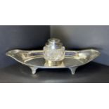 A hallmarked silver desk ink stand with cut glass and silver topped inkwell and silver base,