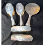 A heavy hall marked silver monogrammed and planished four piece dressing table set comprising,