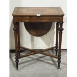 A Victorian walnut and inlaid lady's work table, the lid revealing a fret carved fitted interior