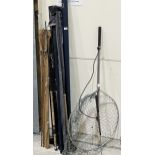 A collection of fly fishing rods, a landing net and a gaff