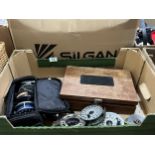 A box of fishing reels and flies