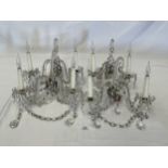 A set of four glass two branch wall lights hung with prismatic drops and bead festoons