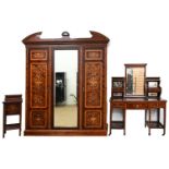 An Edwardian mahogany and inlaid triple wardrobe, dressing table and pot cupboard, with open