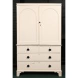 A Victorian pine cupboard, the upper part enclosed by arch panelled doors above four drawer chest,