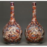 A monumental pair of Japanese Imari vases, Meiji period, typically decorated and of bottle shape,