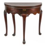 A George II walnut folding tea table, on carved cabriole legs and pad feet, 72cm h, 76cm w Top