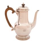 A George VI silver coffee pot with cut card ornament, and of heavy gauge, on gadrooned foot, 22cm h,