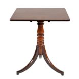 A Victorian mahogany tilt-top tripod table, with oblong top, ring turned column and bun feet, 73cm