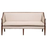 A George IV mahogany settee, upholstered in later spotted fabric, the swept arms on reeded