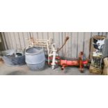 A Victorian cast iron hand pump, later painted red and a smaller later example, a contemporary