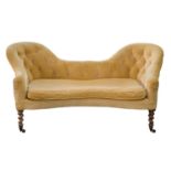 A Victorian sofa,  of serpentine form, in buttoned upholstery with cushion, on turned rosewood