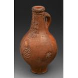 A German salt-glazed brown stoneware Bartmann bottle or Bellarmine jug, 16th/17th c, with typical