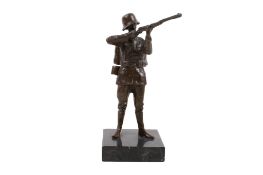 A bronze figure modelled as a German soldier. Raised on a marble base. H17.
