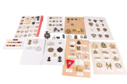 A collection of 19th century and later military badges and accessories.