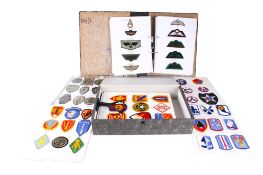 A collection of 20th century British and American military cloth badges.