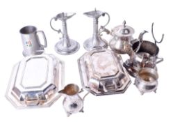 An assortment of silverplate and pewter. Including a pair of candlesticks, ice bucket, tankard, etc.