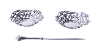 A pair of pierced silver bonbon dishes and a letter opener.