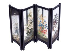 A four-section folding mirrored screen.