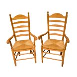 A pair of vintage ladder back kitchen chairs.