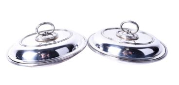 A pair of silveplated entree dishes and covers.