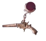 A 9ct gold fob with a gilt metal pendant firearm.