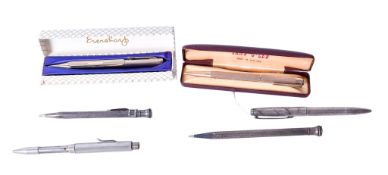A collection of vintage white metal ballpoint pens and a propelling pencil.