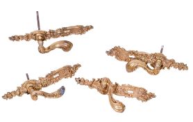 A set of four cast metal gilt door handles. Of scrolling design with hinged handles, L30cm.