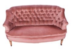A 20th century curved wingback sofa.