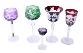 Five Bohemian flash cut glass wine glasses. In various colours and styles, largest H21cm.