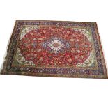 A large Persian style wool rug.