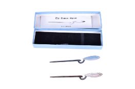 Two silver 'Roman' coffee spoons. Both hallmarked RC, London 1980. Length 10.5g, gross weight 23g.