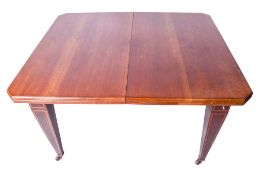 A 20th century mahogany extendable dining table.